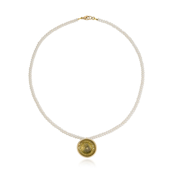 A contemporary pearl necklace with a Citrine ball pendant